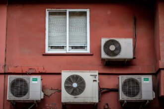 Air conditioning units on the exterior of a residential apartment building in Barcelona, Spain, on Thursday, July 29, 2021. Credit: Angel Garcia/Bloomberg via Getty Images