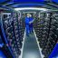 Trainees check the connections a row of power storage units in a commercial battery facility in Schwerin, Germany. Credit: Jens Büttner/picture alliance via Getty Images