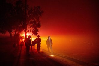 Firefighters monitor flames as they approach a residence in the valley area of Vacaville, northern California during the LNU Lightning Complex fire on August 19, 2020. Credit: Josh Edelson/AFP via Getty Images