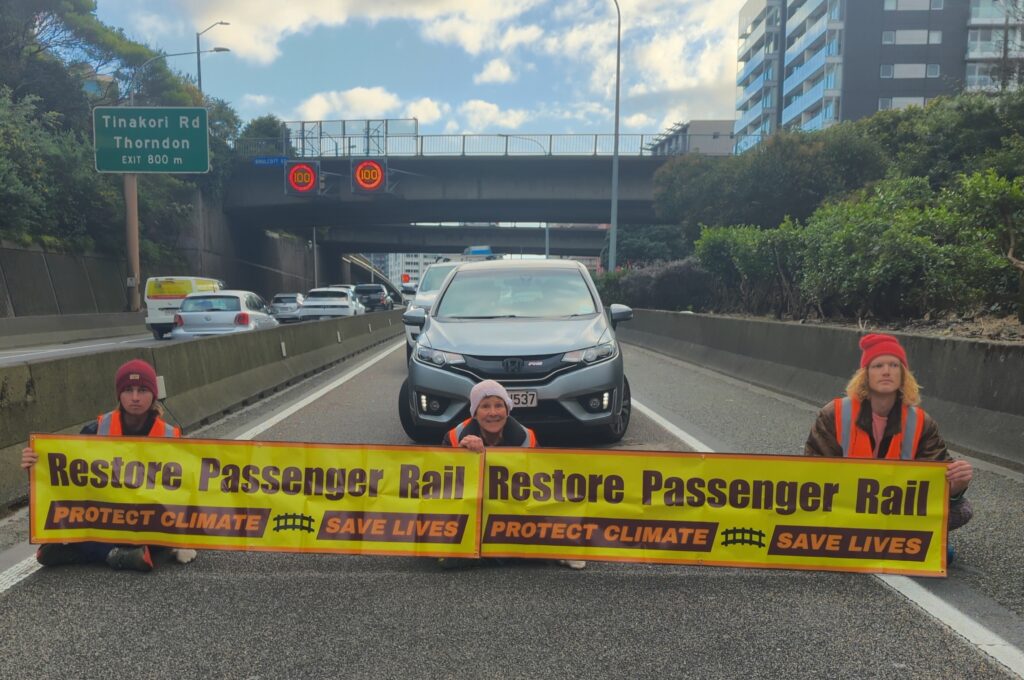 Rosemary Penwarden, center, and two other protestors in Wellington, New Zealand on August 29th. Credit: Photo Courtesy Restore Passenger Rail