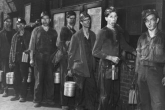 Coal miners, their faces smeared with coal dust in a coal mine, in Cumberland, Kentucky, around 1945. Credit: Curtis Wainscott/FPG/Archive Photos/Getty Images