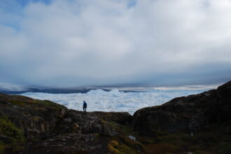 A tourist at the Ilulissat Icefjord, a UNESCO World Heritage site, on Sept. 7, 2022. The ice there has been dramatically receding from year to year. Credit: Natasha Jessen-Petersen