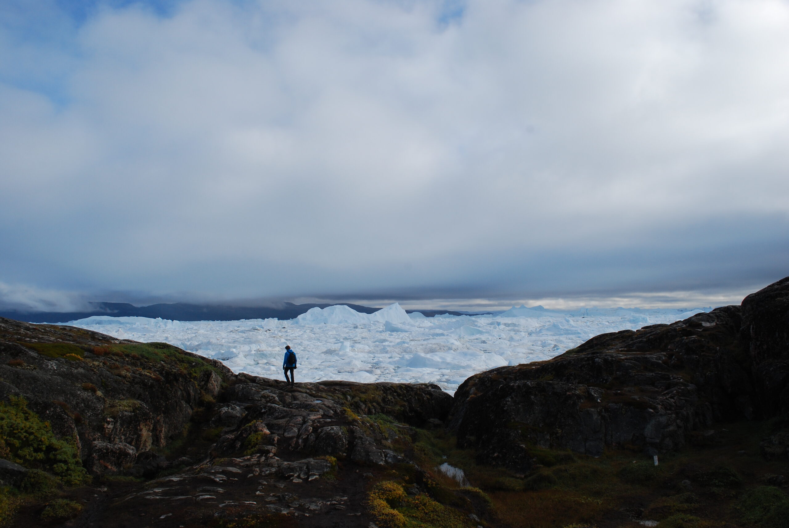 A tourist at the Ilulissat Icefjord, a UNESCO World Heritage site, on Sept. 7, 2022. The ice there has been dramatically receding from year to year. Credit: Natasha Jessen-Petersen