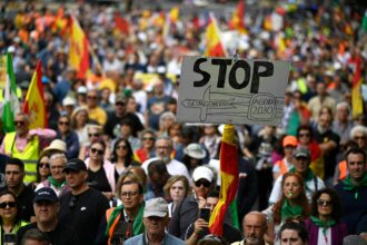 A sign reading 'Stop Geoengineering Agenda 2030' appears at a demonstration of Spanish farmers in Madrid on May 13, 2023. The demonstration was organized by SOS Rural to draw attention to rural living conditions and highlight the importance of agriculture in society and its contribution to the Spanish economy. Credit: Oscar Del Pozo/AFP via Getty Images)