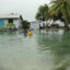 Local residents wade through flooding caused by high ocean tides in Majuro Atoll, the capital of the Marshall Islands, on February 20, 2011, with a warning of worse to come because of rising sea levels.