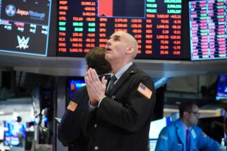 Traders on the floor at the opening bell of the Dow Industrial Average at the New York Stock Exchange on March 18, 2020 in New York.