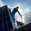 Employees of Sontec GmbH assemble photovoltaic modules on the roof of a residential building in Germany.