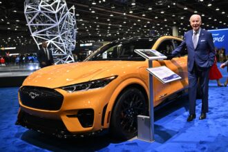 Joe Biden with a Ford Mustang EV at the North American International Auto Show.