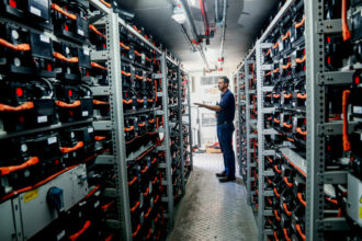 Mike Ferry, with the University of California San Diego Center for Energy Research, shows a bank of Lithium Ion batteries at UCSD