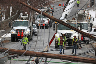 Stoneham, MA - March 1: Emergency personnel dot Montvale Avenue in Stoneham, Mass., after downed power lines trapped cars and trucks.