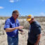 John Allaire (left), a retired oil and gas environmental manager, consulted with James Hiatt, the southwest Louisiana coordinator of the Louisiana Bucket Brigade, in March on Allaire's Cameron Parish, Louisiana property. Venture Global's Calcasieu Pass LNG export terminal is in the background. The proposed Commonwealth LNG terminal would be constructed nearby. Credit: James Bruggers