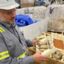 Jay Schabel, president of the plastics division at Brightmark, holds waste plastic from what he described as medical hip replacement parts at the company's new chemical recycling plant in northeast Indiana at the end of July. The plant is designed to turn plastic waste into diesel fuel, naphtha, and wax. Credit: James Bruggers