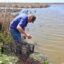 John Allaire checks a trap for fish or crabs on his coastal property in Cameron Parish, Louisiana, south of Lake Charles. Credit: James Bruggers