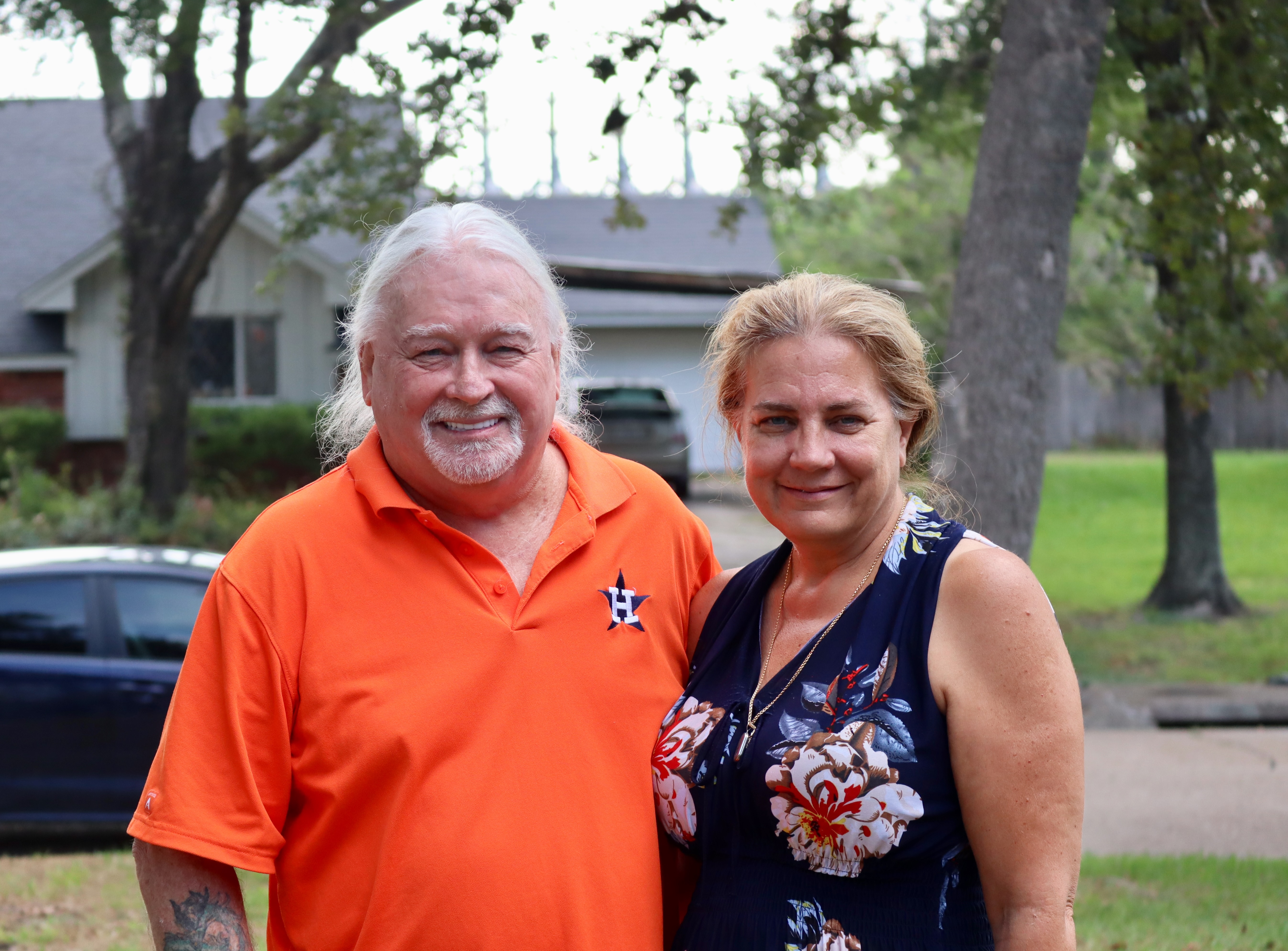 Mike Szumski and Terri Blackwood live in Baytown, Texas, and are worried about a new "advanced recycling" facility for plastic at the ExxonMobil Baytown Complex.  Some of what Szumski calls the "eight dragons," or furnaces, of the ExxonMobil Olefins Plant, can be seen rising from behind a home across the street from Szumski's home. Credit: James Bruggers/Inside Climate News