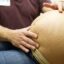 A pregnant woman receives an exam from her doctor. Biomonitoring studies have measured at least 43 chemicals from diverse classes of chemical compounds in 99-100% of pregnant women in the United States. Credit: Jason Connolly/AFP via Getty Images