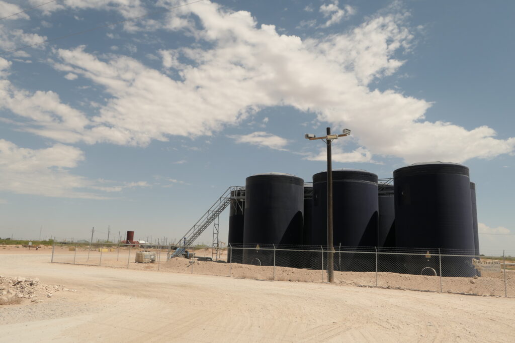 Produced water is stored in tanks outside Pecos, Texas in August 2023. Spills of produced water often occur at storage tanks or from pipelines. Credit: Martha Pskowski/Inside Climate News