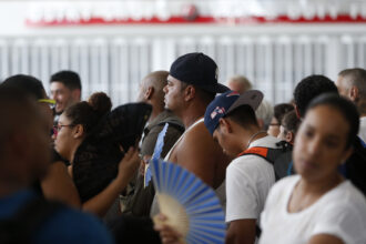 People wait in line for a flight out in a sweltering San Juan Airport in San Juan, Puerto Rico on Sept. 29, 2017. Credit: Jessica Rinaldi/The Boston Globe via Getty Images