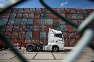 Shipping containers behind a fence at the Southampton docks in the UK. Credit: Matt Cardy/Getty Images