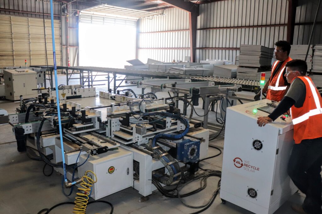 At We Recycle Solar in Yuma, Arizona, workers feed panels into a machine that separates the electricity-generating components from the panels' frames. Credit: Emma Peterson.