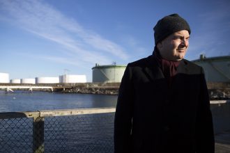 Mayor Claude Morgan stands near some of South Portland's petroleum tanks. Credit: Brianna Soukup/Portland Press Herald via Getty Images