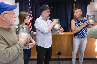 Maine DEP Air Bureau Senior Chemist Danielle Twomey trains South Portland residents Jay DeMartine, Annika Frazier and Ryan Frazier to use portable air-collection canisters. Credit: Carl D. Walsh/Portland Press Herald via Getty Images