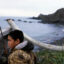 Steven James, 12, waits to hunt geese on St. Lawrence Island, in Alaska, sitting hidden behind a wood bar and a whale bone. Credit: Ann Johansson/Corbis via Getty Images.