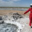 Oil and gas lawyer Sarah Stogner visits Lake Boehmer in Pecos County where abandoned wells have brought produced water to the surface for decades. The Railroad Commission considers these water wells and therefore not under their jurisdiction. Credit: Martha Pskowski/Inside Climate News