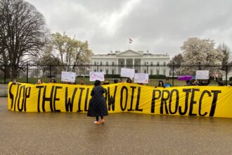 Holding a banner opposing the Willow oil project in Alaska, demonstrators gathered on Friday to urge President Biden to reject the proposal. Credit: Aman Azhar/Inside Climate News.