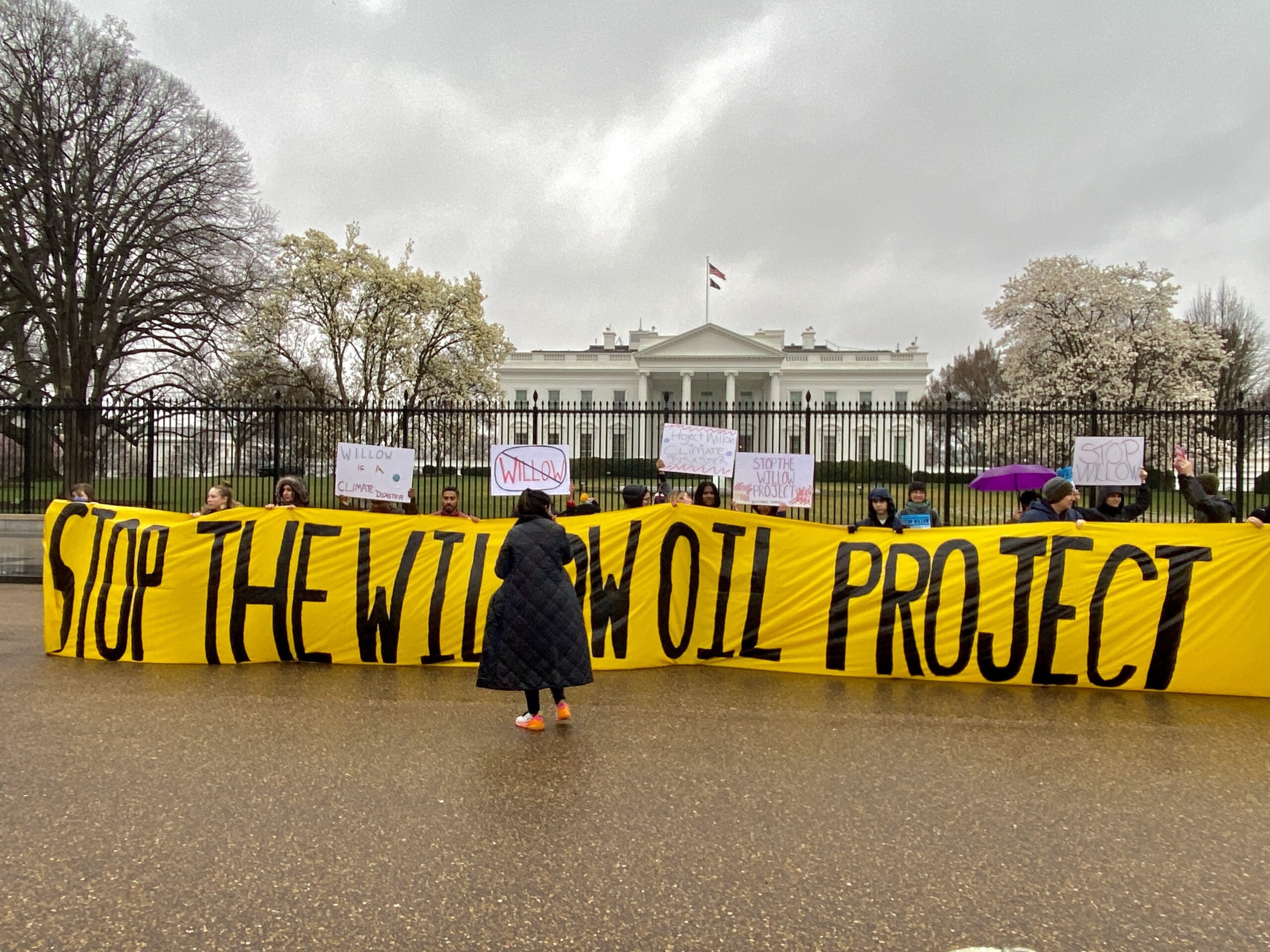 Holding a banner opposing the Willow oil project in Alaska, demonstrators gathered on Friday to urge President Biden to reject the proposal. Credit: Aman Azhar/Inside Climate News.