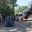 Sudanese security forces intervene in October 2021 as smoke billows from tyres set on fire by Sudanese students in the city of Nyala, the capital of South Darfur, demonstrating against the hikes in bread prices due to low wheat supply following the closure of Sudans' Red Sea port of Port Sudan. Credit: Abdelmonim Madibu/AFP via Getty Images.