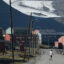 A man wearing shorts and a t-shirt walks in the town center as the melting Longyear glacier looms behind during a summer heat wave on Svalbard archipelago on July 30, 2020 in Longyearbyen, Norway. Credit: Sean Gallup/Getty Images