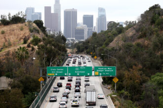 Cars make their way toward downtown Los Angeles, notorious for traffic and air pollution, a silent killer now linked to brain development problems in young children. Credit: Mario Tama/Getty Images.