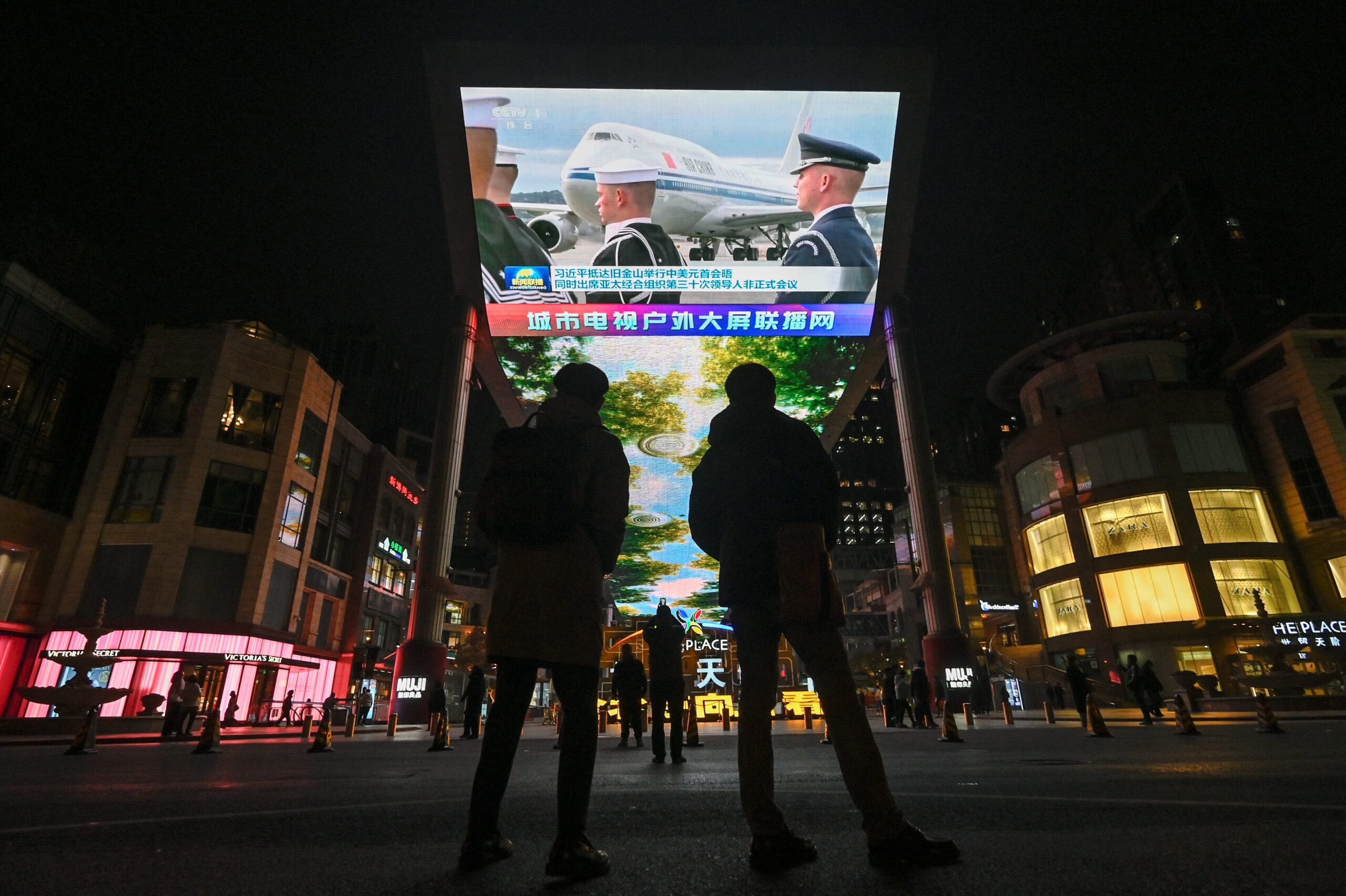 A large screen outside a shopping mall in Beijing shows news coverage of the arrival of Chinese President Xi Jinping at San Francisco International Airport on Wednesday, after China and the United States released a joint statement of cliimate cooperation. Credit: Pedro Pardo/AFP via Getty Images