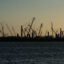 Construction cranes stand silhouetted by the sunset at the Golden Pass LNG Terminal in Sabine Pass, Texas, in April 2022. Golden Pass LNG, a joint venture between ExxonMobil and Qatar Petroleum, began as an import terminal and construction seen today will create export capability. Credit: The Washington Post via Getty Images