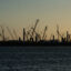 Construction cranes stand silhouetted by the sunset at the Golden Pass LNG Terminal in Sabine Pass, Texas, in April 2022. Golden Pass LNG, a joint venture between ExxonMobil and Qatar Petroleum, began as an import terminal and construction seen today will create export capability. Credit: The Washington Post via Getty Images