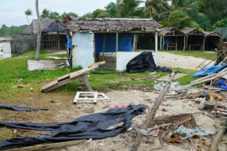 Badly damaged buildings are pictured near Vanuatu's capital of Port Vila on April 7, 2020, after Tropical Cyclone Harold swept past and hit islands to the north. The cyclone caused $600 million in damage, some 60 percent of the small Pacific island nation's GDP. Credit: PHILIPPE CARILLO/AFP via Getty Images.