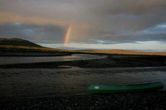 A rainbow touches down on the Kokalik River, in northwestern Alaska, winds its way through the National Petroleum Reserve. Credit: Andrew Lichtenstein/Corbis via Getty Images